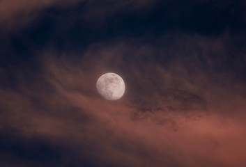 Naklejka na ściany i meble Sunset Clouds Moving over the Moon