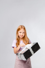 red-haired girl holding a gift box