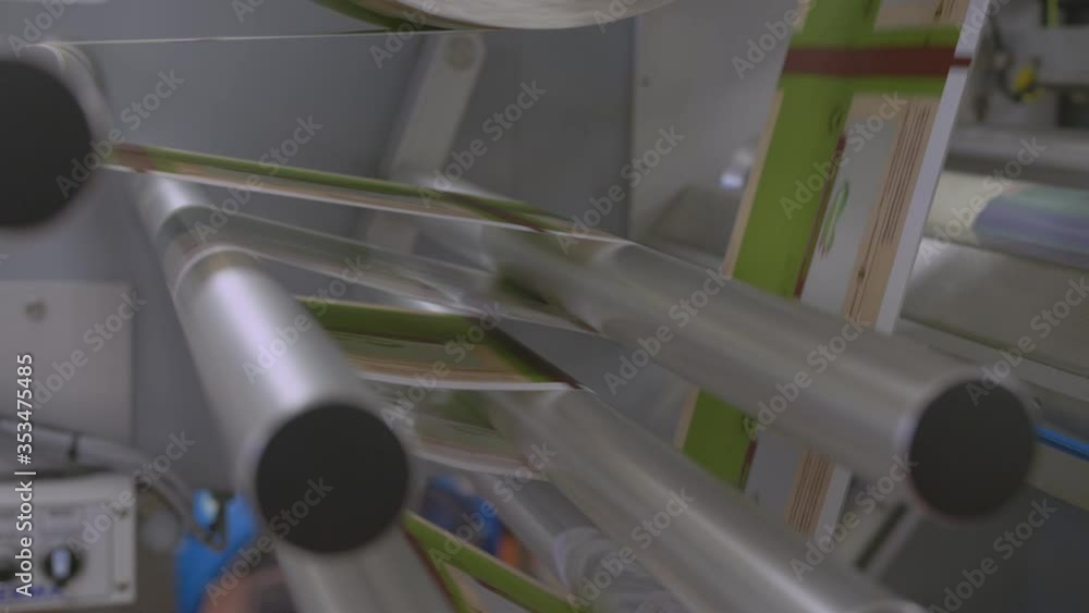 Poster close up of rollers processing packaging on an automated production line of food items