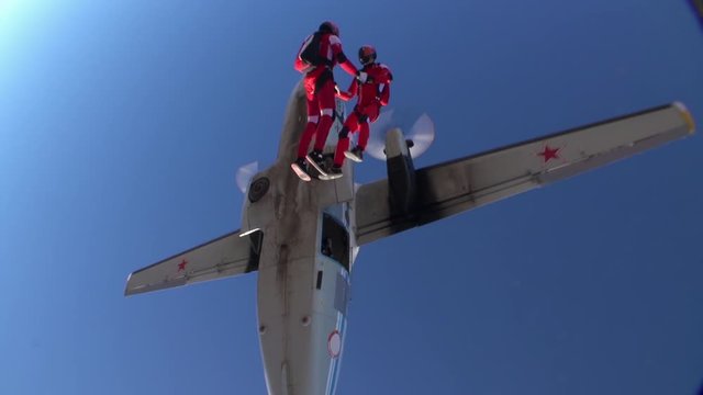 Two sports parachutist build a figure in free fall. Extreme sport concept.