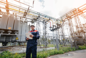 The energy engineer inspects the equipment of the substation. Power engineering. Industry