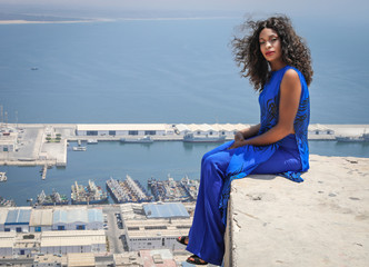Fototapeta na wymiar Beautiful girl on the background of a panoramic view of the city of Agadir.