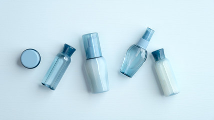 Set of water based cosmetic on blue background. SPA natural organic beauty products bottles without label, packaging design mockup