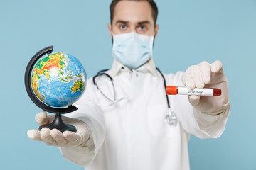 Male doctor man in medical gown face mask gloves isolated on blue background. Epidemic pandemic...