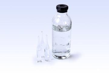 glass ampoules with medicinea and saline bottle isolated on white background