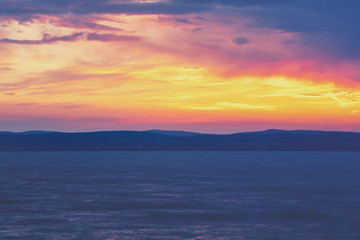 Nature landscape. Embankment of the lake in the evening with a dramatic sky. Sunset over lake Balaton, Hungary, Europe