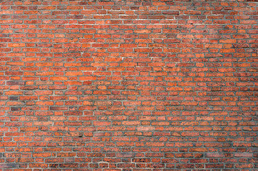 Naklejka premium Weathered red brick wall background, texture