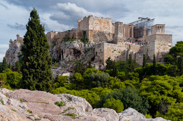 Fototapeta na wymiar The Acropolis of Athens city in Greece with the Parthenon Temple (dedicated to goddess Athena) as seen from the vantage point of Areopagus Hill in Plaka district on a sunny day with cloudy sky