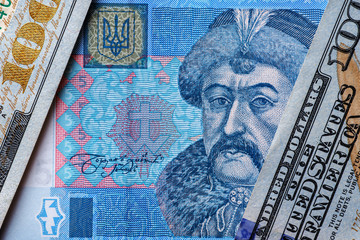 Ukrainian money - hryvnia banknotes USA dollars bills. Finance in Ukraine, of the hryvnia to the dollar exchange rate. World economic crisis associated with coronovirus.