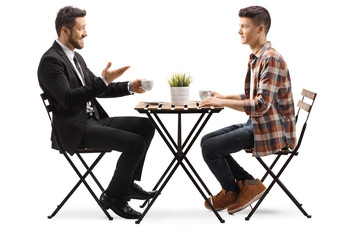 Businessman sitting in a cafe with a young male student