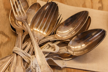 Silverware with bunch of silverware varieties including forks spoons. Close up of bunch.