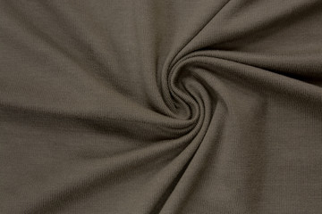 Brown plain bright knitwear. Faux draped fabric with pleats, jersey, can be used as background