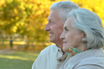 Happy senior woman and man in park