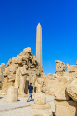 Granite obelisk against blue sky in a Karnak temple. Luxor, Egypt.
