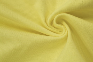 Yellow plain bright knitwear. Faux draped fabric with pleats, jersey, can be used as background