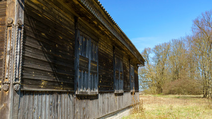 Rustic house wall with closed windows and cracked paint. Space for text. Countryside concept.