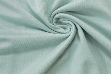Light blue plain bright knitwear. Faux draped fabric with pleats, jersey, can be used as background