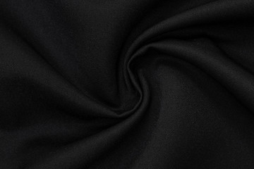 A Black Polyester Clothes, Textile, Fabric Cushion as a Background, Texture. Black polyester...