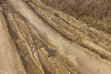 Beautiful dirt and gravel dust road path on the highland of Europe. A muddy rough terrain for an extreme 4WD 4x4 car. Sand dune off-road motocross and motorsport track