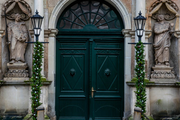 Main entrance of St. Peter's Church with statues and streetlamps, Old Riga Latvia