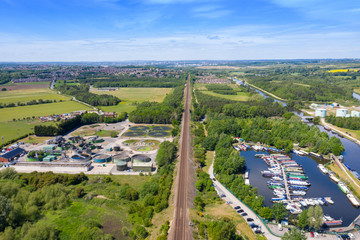 Naklejka premium Aerial photo of a Water Treatment plant along side a boating harbour on a beautiful sunny summers day in the town of Methley in Leeds West Yorkshire in the UK along side train tracks