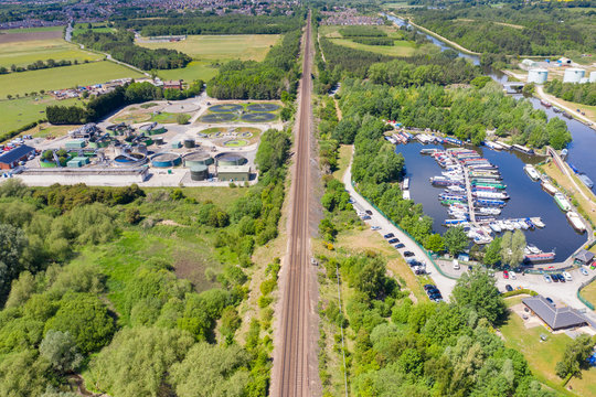 Aerial photo of a Water Treatment plant along side a boating harbour on a beautiful sunny summers day in the town of Methley in Leeds West Yorkshire in the UK along side train tracks