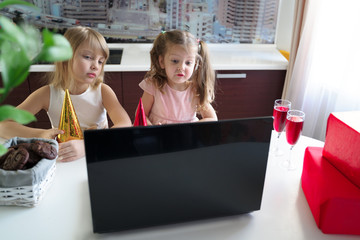 Kids virtual birthday party.Girls in dresses and caps celebrate holiday with friends on...