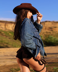 western  cowgirl with a whip in a sheriff hat - obrazy, fototapety, plakaty