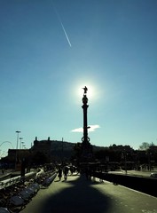The Columbus monument photograph against the sun.