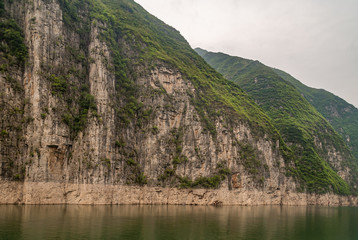 Wushan, Hubei, China - May 7, 2010: Wu Gorge in Yangtze River. Straith down brown and black cliff...