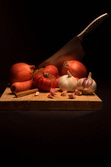 View of vegetables on slicing board with knife