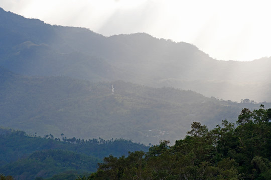 Cloudy sunset over jungle covered mountain, Philippines