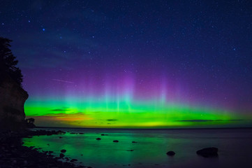 Fototapeta na wymiar Aurora Boralis showing its beauty over the Baltic sea on an clear winter night outside the island of Gotland in Sweden