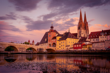 Stone bridge and cathedral of Regensburg from very low perspective at sunset