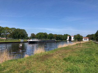 Cargo ship at a canal lock at the twente canal