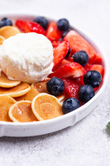 Sweet tiny pancake cereals with berries