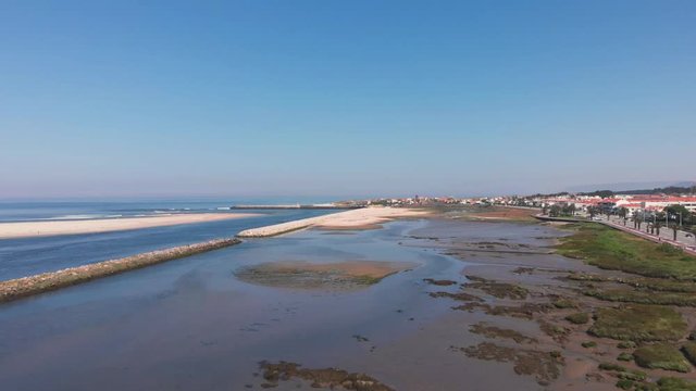 DRONE The two sides of Restinga de Ofir. One facing the ocean, the other the estuary of C&aacute;vado River. The jetty structure that protects the coastline from the currents and tides in Esposende, Portugal