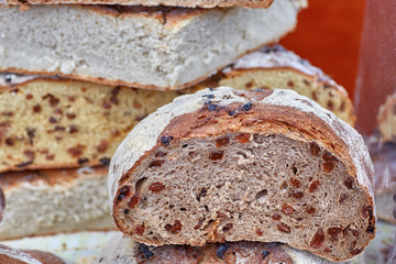 Close-up of artisan bread with grapes passes inside it.