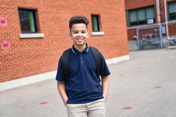 The Great Portrait Of School Pupil Outside Classroom Carrying Bags