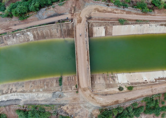 Aerial view of a bridge on the clean canal. Top view of a canal.