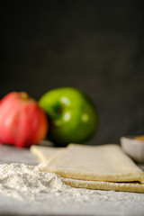 Raw dough for apple pie on a dark background. Hight quality photo