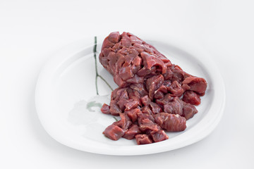 Uncooked,chopped  beef meat on white paper.Close-up taken.Sacrifice Feast Concept.