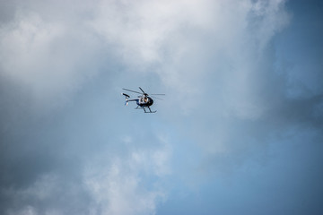 A single helicopter with a dark and cloudy background