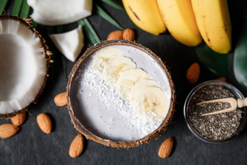 Smoothie bowl in coconut shell with banana