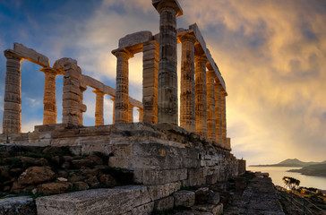 Fototapeta na wymiar Temple of Poseidon at Cape Sounion, Attica / Greece. One of the Twelve Olympian Gods in ancient Greek religion and myth. He was god of the Sea, other waters and of earthquakes. Sunset with cloudy sky