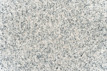 The surface texture of a gray natural granite slab.
