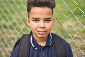 The Great Portrait Of School Pupil Outside Classroom Carrying Bags
