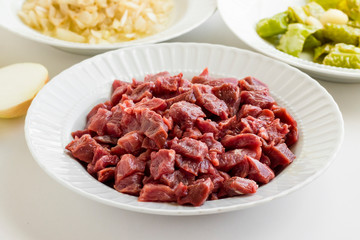 Uncooked,chopped beef meat ready for cook in plate.Festive braised meat ingredients.