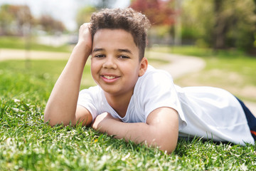 Teen afro american boy in the garden on the day time