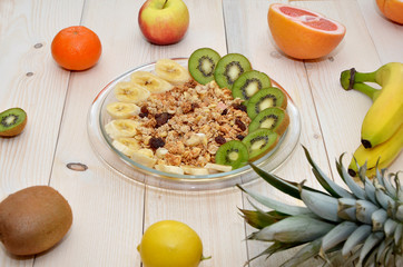 muesli and fresh fruit breakfast on a wooden table